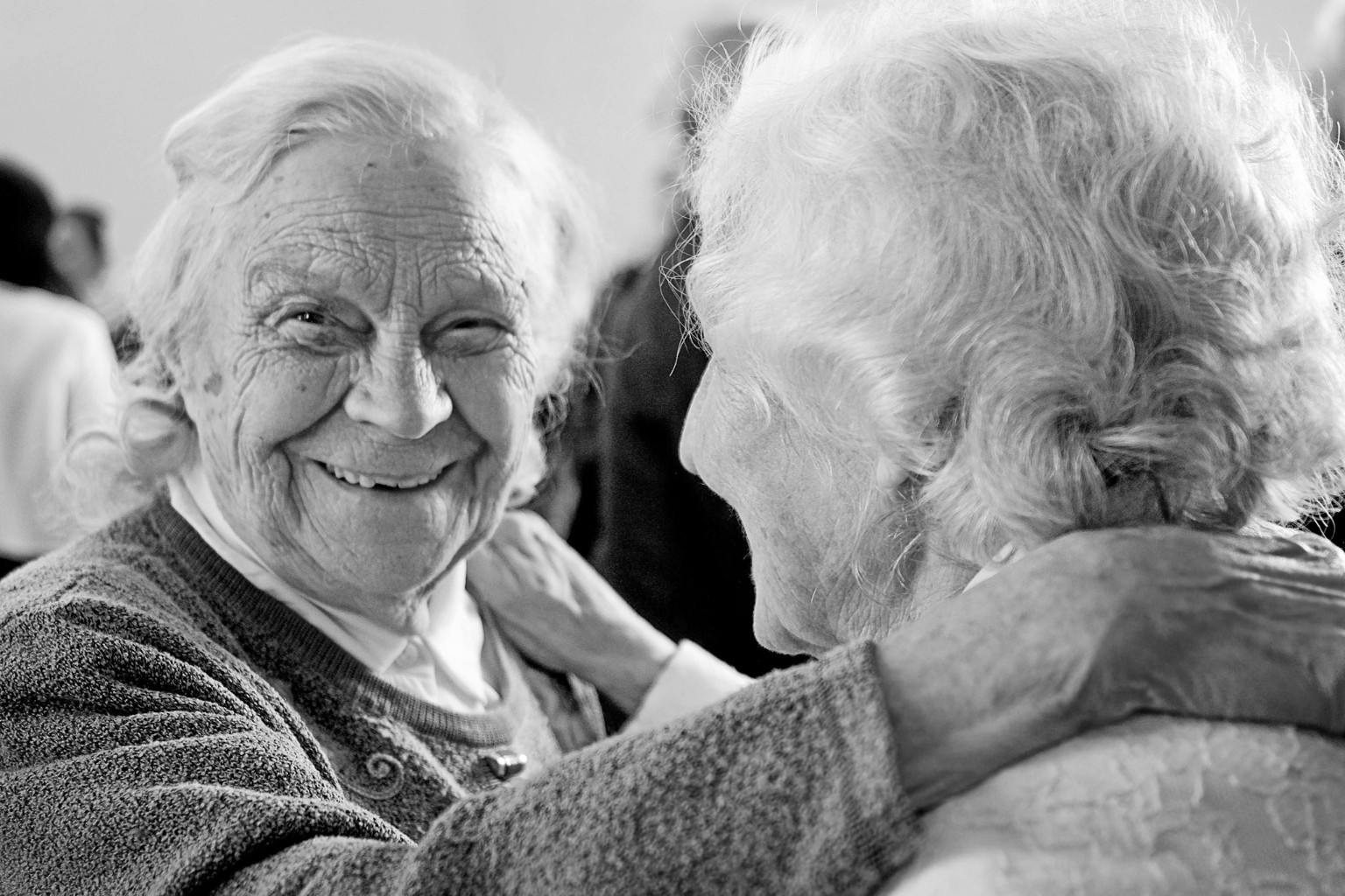 Two older women sharing a warm embrace
